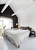 Attic bedroom with black gable-end wall
