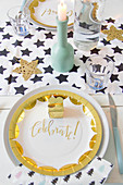 Table festively set with gold paper plates