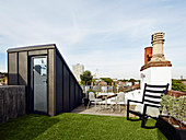 Artificial lawn on roof terrace with city view