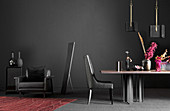 Black armchair, chair and table in front of black wall