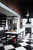 Renovated kitchen in black and white with glossy ceramic floor tiles