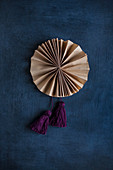 Hand-made paper rosette with tassels