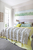 Fringed blanket on bed in bright bedroom