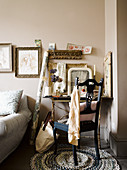 Antique chair at desk with vintage-style ornaments and sections of gilt frames