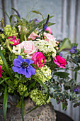 Colourful spring bouquet with blue, pink and green flowers