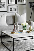 Feminine ornaments on delicate coffee table with marble top
