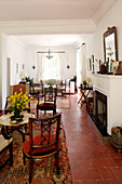 Fireplace and terracotta floor tiles in Mediterranean lounge