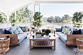 Sofas with pillows and coffee table on covered terrace