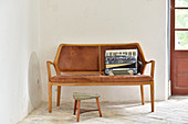 Accordion on wooden bench with leather upholstery