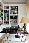 Bookshelves and designer desk in small study