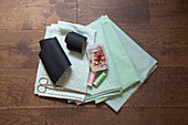 Chalkboard fabric and sewing utensils on mint-green patterned fabrics