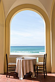 Table and two chairs in loggia with picturesque panoramic sea view