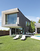 Clipped lawn surrounding architect-designed house with swimming pool