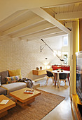 Open-plan interior with brick wall and suspended ceiing