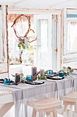 Festively set dining table in beach house