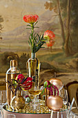 Table decoration in gold tones and proteas on a mirrored pedestal