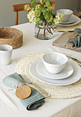 Table set in natural shades with wooden discs on napkin rings