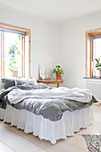Romantic bed with valance in simple bedroom