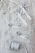 Festive name tags handmade from strips of paper and gingham ribbon