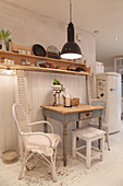 Shabby-chic dining area against white board wall