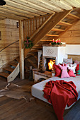 Cosy couch with cushions next to wood-burning stove