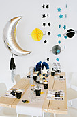 Space party: table festively set for child's birthday party