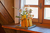 Vase made from corn cobs on windowsill