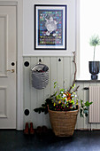 Autumnal branches in basket in rustic hallway