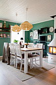 Petrol-blue walls and wood-fired stove in dining room