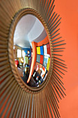 Sunburst mirror on orange wall