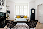 Black-and-white living room with two yellow scatter cushions on sofa