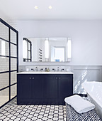Patterned tiled floor in classic, black-and-white bathroom
