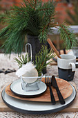 Christmas place setting decorated with fryer basket, bauble and feathers