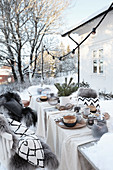 Set table with Christmas decorations in garden