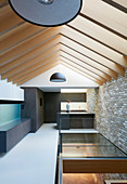 Open roof structure in modern architect-designed house in mixture of materials