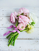Posy of ranunculus on wooden surface