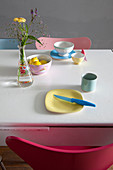Colourful breakfast crockery on white table