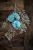 Ornamental leafy branch and turquoise Christmas decorations