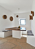 Masonry benches and table with wooden top in white dining area