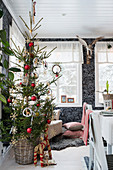 Christmas tree in dining area with black patterned wallpaper