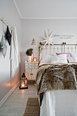 Double bed and Christmas decorations in bright bedroom