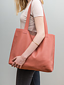 A woman with a homemade leather shopping bag