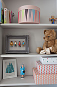 Toys on pale grey shelves