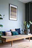 Velvet cushions in shades of blue on 50s couch