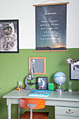 Two-tone wall and space-themed accessories in boy's bedroom