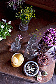 Fruit, chutneys and flowers in glass jars and vases