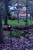 Villa with illuminated windows in woods