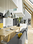 Dining room in shades and grey and white with many wooden elements in architect-designed house