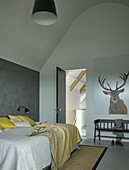 Modernes Schlafzimmer in Grautönen mit hoher Decke