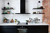 Modern, black fitted kitchen with white worksurface